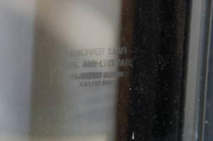 Tempered glass windows usually have an etched marking on the glass in the corner of the window that includes the supplier's name, place of fabrication, date manufactured, thickness, and certifications or safety standards the glass meets.