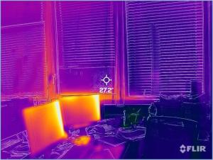 This infrared image shows little heat gain from north-facing double-pane windows with blinds, but significant heat output from computer monitors