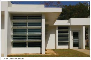 Right - This home's windows have protective coverings that are raised to provide shade in good weather and can drop to protect the windows during high wind events.