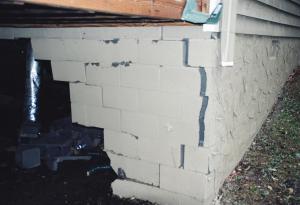 This concrete block foundation cracked due to lack of steel rebar reinforcement.