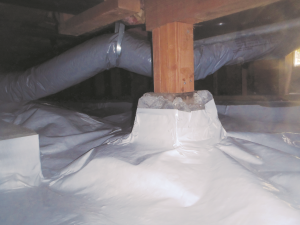 Wrong - The vapor retarder does not completely cover the pier block and is not sealed to the post; the support strapping pinches the flex duct.