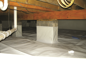Right - The posts and floor of this crawlspace are covered with a heavy sheet of vapor retarder that is sealed to the post, the walls, and at all seams.