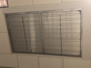 This damper located at the top of a stairwell in a multistory building is automatically kept closed to reduce energy loss; it automatically opens during a smoke event.
