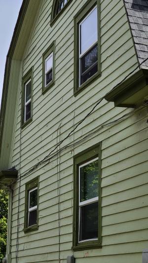 Wrong - Wiring holes are not sealed and possible missing flashing around windows is allowing water into walls and causing paint to peel.