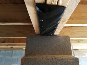 Wrong - A vapor barrier should cover the top of the concrete block pier support in the crawl space.