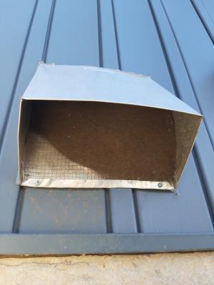 Wrong - Vent screening on outdoor air intake has been clogged with dirt and screen has been pulled up into vent and is no longer covering the entire opening.
