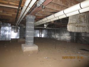 Right – Foil-faced insulation was added after the crawlspace was dried and sealed by diverting water runoff, sealing off crawlspace windows and vents, and adding sump pumps and exhaust fan ventilation