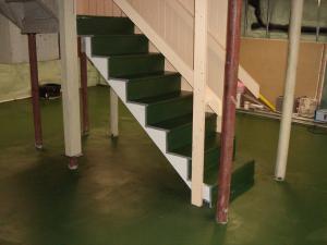 Epoxy paint is installed to provide a moisture control layer on the surface of an existing basement slab