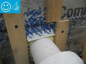 Right - This duct penetration is properly flashed and integrated with the taped, foil-faced foam sheathing layer, which serves as the air and water barrier
