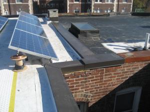 Metal cap flashing is installed over the roof parapet and extends down over the roofing membrane