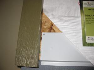 Flashing covers the bottom edge of this wall sheathing then housewrap is layered over the top edge of the flashing.