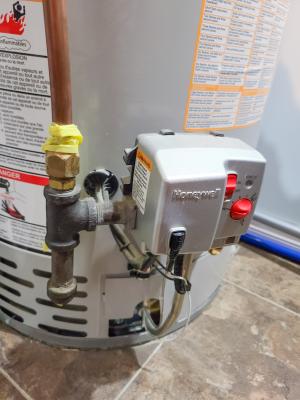 This water heater has the temperature settings on a control box attached to the front of the water heater.