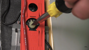 To adjust this water heater’s temperature, turn the dial to 120°F with a flathead screwdriver.