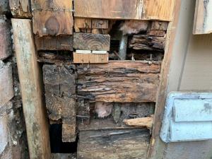 Wrong - Lack of a weather-resistant barrier allowed water to get behind the siding and rot the framing in this corner rim joist area.