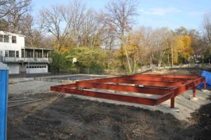 To handle the high water table on this lot, the builder installed underground drain pipe to french drains for slow dispersal of storm runoff, then set the floor joists on steel framing set 4 ft above grade on 35-foot-deep piers.
