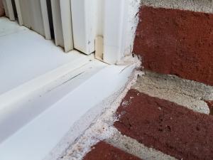 Wrong - Window sill trim was too tall for window frame and was poorly modified in an attempt to provide drainage out of the window.