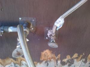 Wire hardware mesh is fastened with a staple gun and screws to the wall to prevent pests from entering the building through small holes and cracks