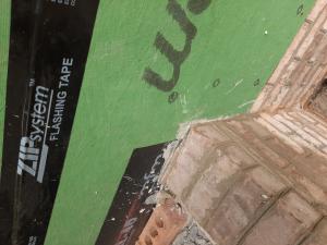 Wrong - Flashing tape is missing behind the right edge of the brick wall.