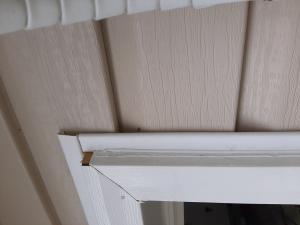 Wrong - Vinyl siding in incorrectly installed under not over door trim and door trim channel pieces are missing.