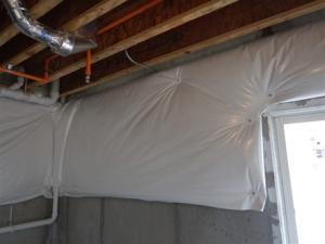 Wrong - This plastic-covered blanket insulation is not perforated, does not cover the entire basement wall, is not sealed at the edges, and is not installed over rigid foam.