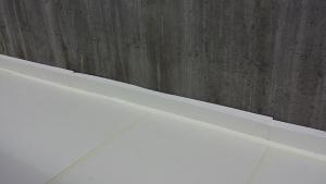Four inches of rigid foam separate the concrete slab from the ground and the foundation walls. 