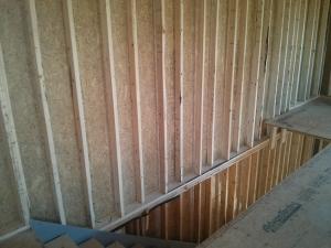 The basement is half in and half out of the ground with only 4 feet below grade, which allows for full 36-inch-tall windows that are completely above grade.