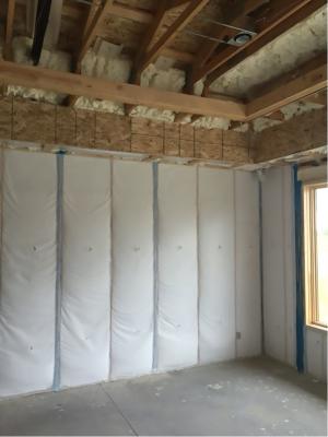 The rim joists and top plates are air sealed and insulated with open-cell spray foam while the walls are filled with blown fiberglass.