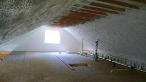 This attic is insulated to R-64 with a hybrid application of 11 inches of open-cell spray foam (R-4.45/in) plus 2 inches of closed-cell spray foam (R-7.4/in) that completely fills the roof rafter cavities and encases the rafters.