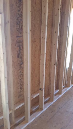 The exterior walls are double walls consisting of two 2x4 stud walls set 3 inches apart to form a 10-inch-thick wall cavity that is filled with blown-in fiberglass to provide a continuous R-40 blanket of insulation around the home. 