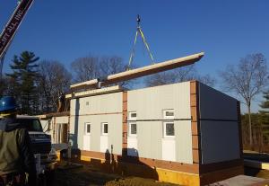 The walls and floors of this modular home were constructed in a factory and are brought to the site already insulated and ready for quick assembly.
