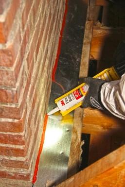 If there are gaps larger than ¼ inch around a chimney in the attic, install sheet metal to cover the openings, secure the sheet metal to surrounding framing with screws or heavy staples, and seal all joints and seams with fire-rated caulk.