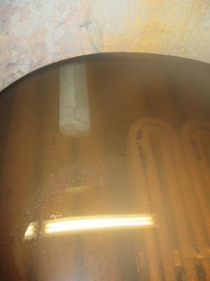 An anode bar (upper grey bar) is installed in a steel boiler
