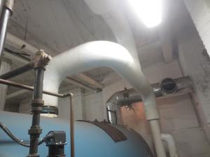 In this traditional steam header, the steam makes a 90-degree turn to supply the building, while the heavier water droplets are carried back to the boiler