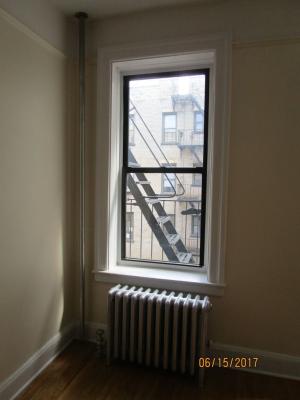 The exposed riser shown here also supplies the radiator. A short pipe runs under the floor to the hand valve. 