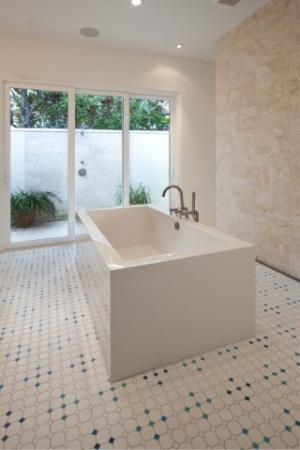 An outdoor shower off the master bathroom keeps heat and humidity outside for this hot-humid climate home.