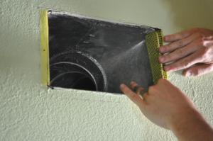 Duct boot is air sealed to ceiling by covering the seam with fiberglass mesh tape and mastic