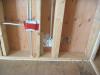 Right - Comprehensive air sealing of the walls includes caulking of the subfloor-sill plate seams and corner seams, taping of electrical boxes, and spray foaming around pipe penetrations.