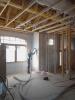 After spraying the 2x6 wall cavities with 2 inches (R-13) of closed-cell spray foam, the walls are covered with netting and an additional 3.5 inches of fiberglass (R-13) is blown in. 