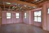 Right - The rigid metal HVAC ducting is installed between the floor joists rather than in an unconditioned attic or crawl space to minimize heat loss.