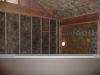Extra-wide air sealing tape seals seam where the structural insulated panels (SIPs) that form the roof and walls meet. 