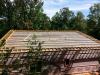 On top of the ice-and-water shield, the builder installed horizontal beams that were raised 6 inches off the deck to allow room for spray foam insulation. 