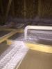 Spray foam insulation insulates and air seals around plumbing pipes and top plates in the attic.