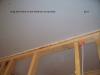 The ceiling drywall is sealed to the top plates with caulk.