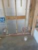 The foam-filled concrete block walls are lined on the interior side with foil-faced rigid foam then topped with furring strips for attaching drywall. 