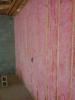 Unfaced batt insulation completely fills the wall cavities.