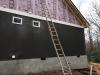 Extruded polystyrene (XPS) rigid foam is taped at the seams to provides a continuous air and weather-resistant barrier so no house wrap is needed; it also provides a continuous layer of insulation.