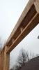 A layer of rigid foam is sandwiched between two layers of 2x8 lumber in this insulated header over a window.