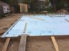 Rigid foam extends under the full slab and lines the inside edges of the foundation walls.