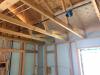 Rigid foam serves as the sheathing on these 2x6 24-inch on center walls; plywood is used only at the corners for wind bracing. 