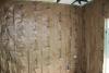This fiberglass batt insulation has a kraft paper facing that is correctly stapled to the face rather than the sides of the wall studs to minimize compression.